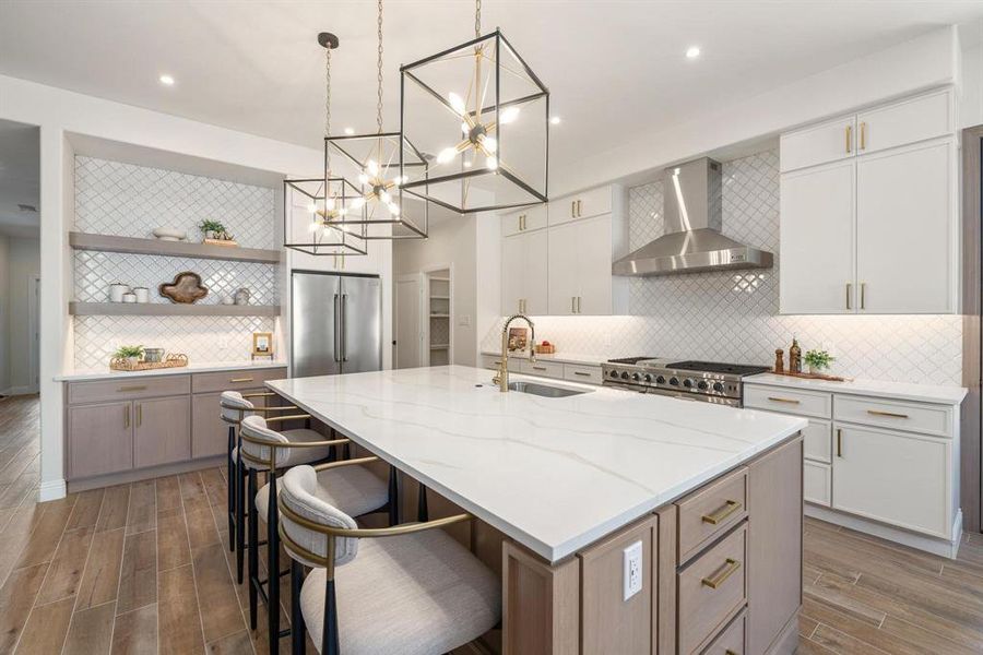 Kitchen featuring open shelves, backsplash, wood finish floors, light stone countertops, and recessed lighting Kitchen featuring open shelves, backsplash, wood finish floors, light stone countertops, and recessed lighting