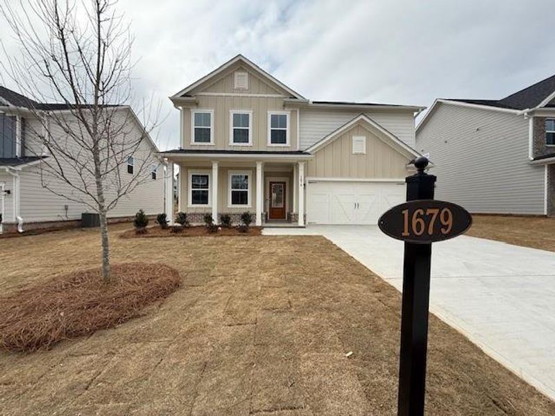 Front exterior of a new home in Berkeley Mill, Cumming, GA, highlighting curb appeal (Image 1). Front exterior of a new home in Berkeley Mill, Cumming, GA, highlighting curb appeal (Image 1).