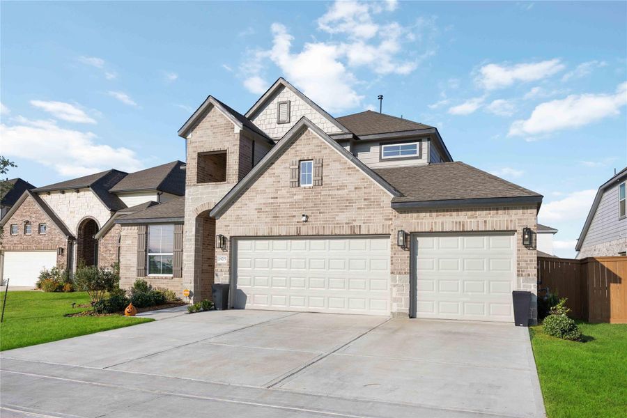 Alternate front view showcasing driveway and landscaping. Alternate front view showcasing driveway and landscaping.