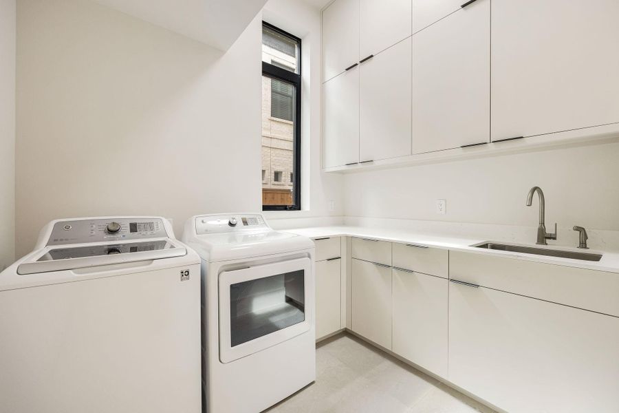 [UTILITY-1ST FLR] Conveniently located on the first floor, the spacious utility room is thoughtfully designed with abundant cabinetry, generous workspace, and exceptional storage to simplify everyday living.