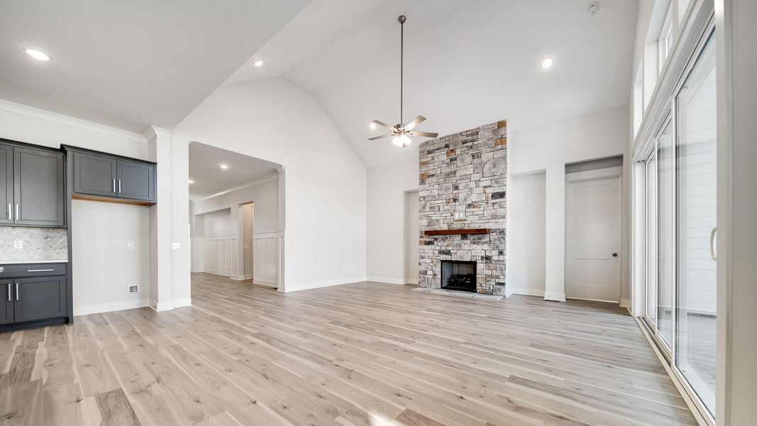 Large great room with vaulted ceilings and stone fireplace