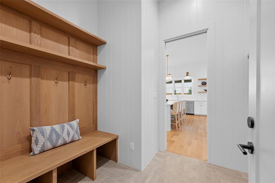 Designer mudroom with convenient entrance from garage to kitchen.