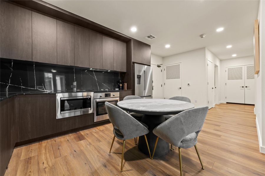 Rich wood cabinetry and sleek stone surfaces define this modern culinary space. Rich wood cabinetry and sleek stone surfaces define this modern culinary space.