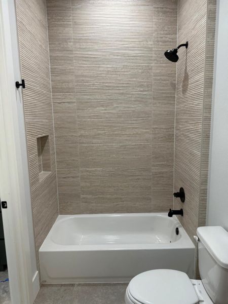 Bathroom with toilet and tub / shower combination