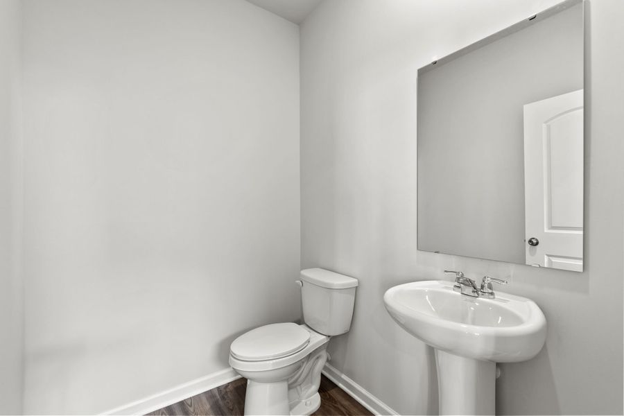 A bathroom with a toilet and sink.