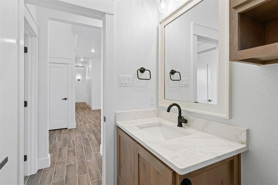 Bathroom with wood tiled floors and vanity Bathroom with wood tiled floors and vanity