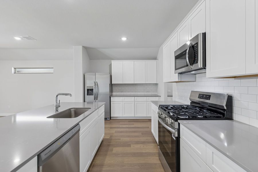 Kitchen in the Harrison home plan by Trophy Signature Homes – REPRESENTATIVE PHOTO