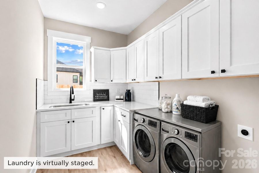 Laundry room virtually staged with dryer & washer.