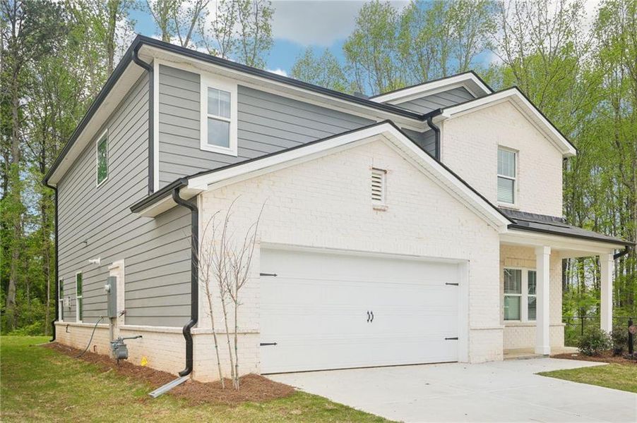 Front exterior of a new home in Westmont Preserve, Powder Springs, GA, highlighting curb appeal (Image 21). Front exterior of a new home in Westmont Preserve, Powder Springs, GA, highlighting curb appeal (Image 21).