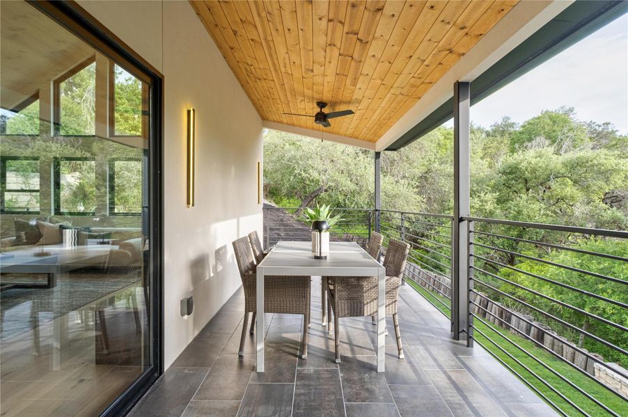 Covered patio featuring ceiling fan. Overlooking private backyard