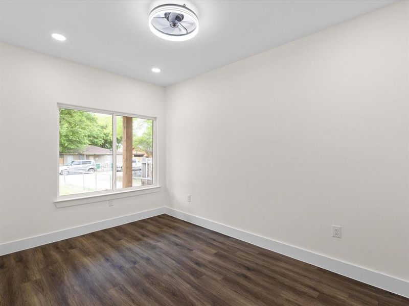 Unfurnished room featuring dark wood finished floors and recessed lighting