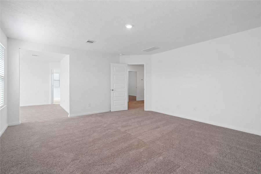 Another view from the primary bedroom looking to the sitting area that leads to the primary bathroom.