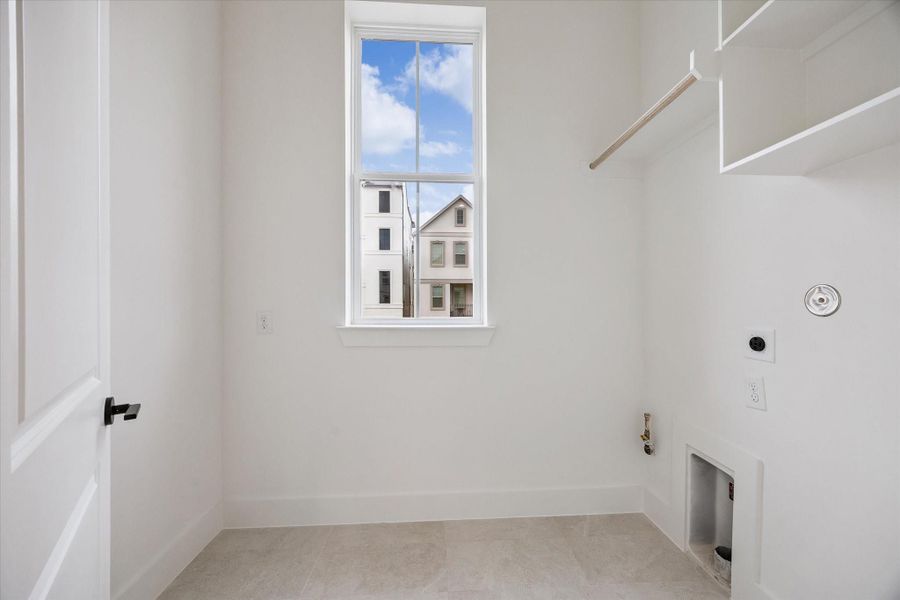 Second-floor laundry room centrally located for convenient access from both the first and third floors.