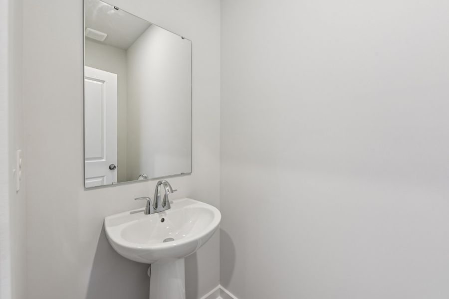 A bathroom with a mirror and sink.