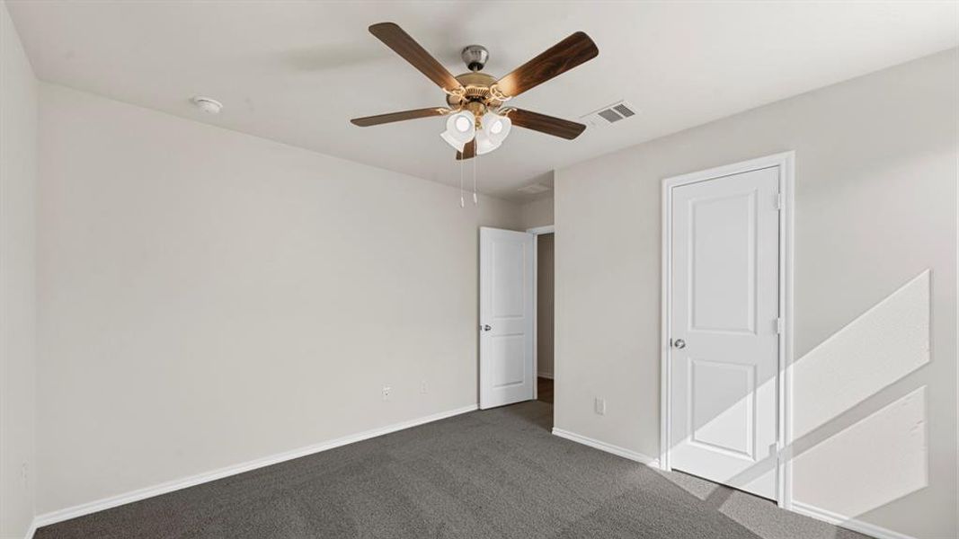 Spacious room featuring neutral painted walls, gray carpet flooring, and white baseboards Spacious room featuring neutral painted walls, gray carpet flooring, and white baseboards