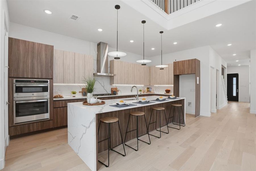 Calacatta white quartz waterfall island · flat-panel frameless cabinetry · GE stainless appliances · vented designer hood · undercabinet lighting — the kitchen that makes hosting feel effortless Calacatta white quartz waterfall island · flat-panel frameless cabinetry · GE stainless appliances · vented designer hood · undercabinet lighting — the kitchen that makes hosting feel effortless