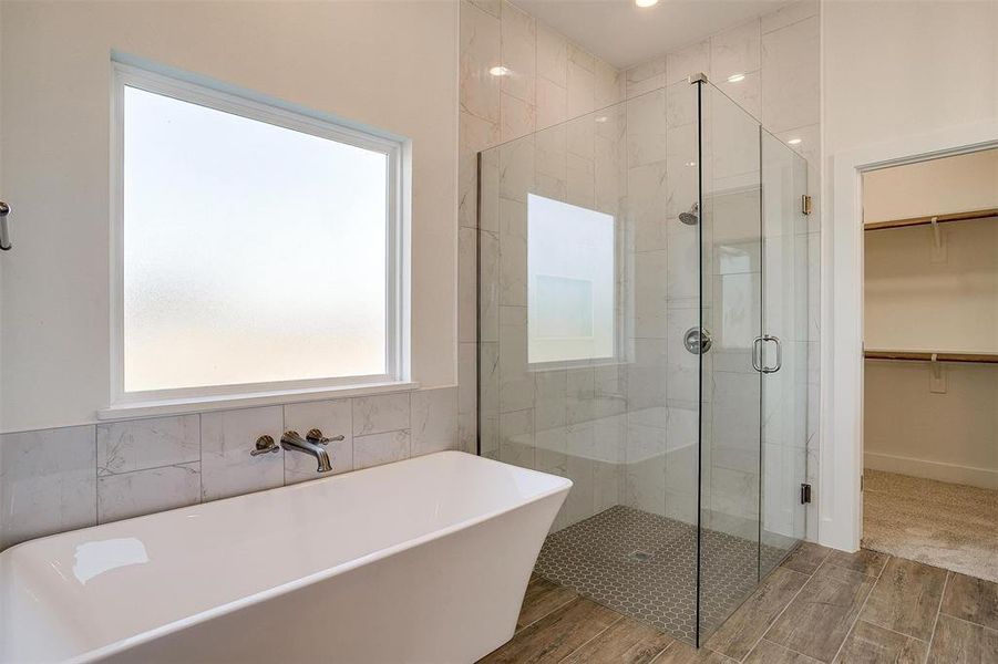 Bathroom featuring hardwood / wood-style floors and independent shower and bath