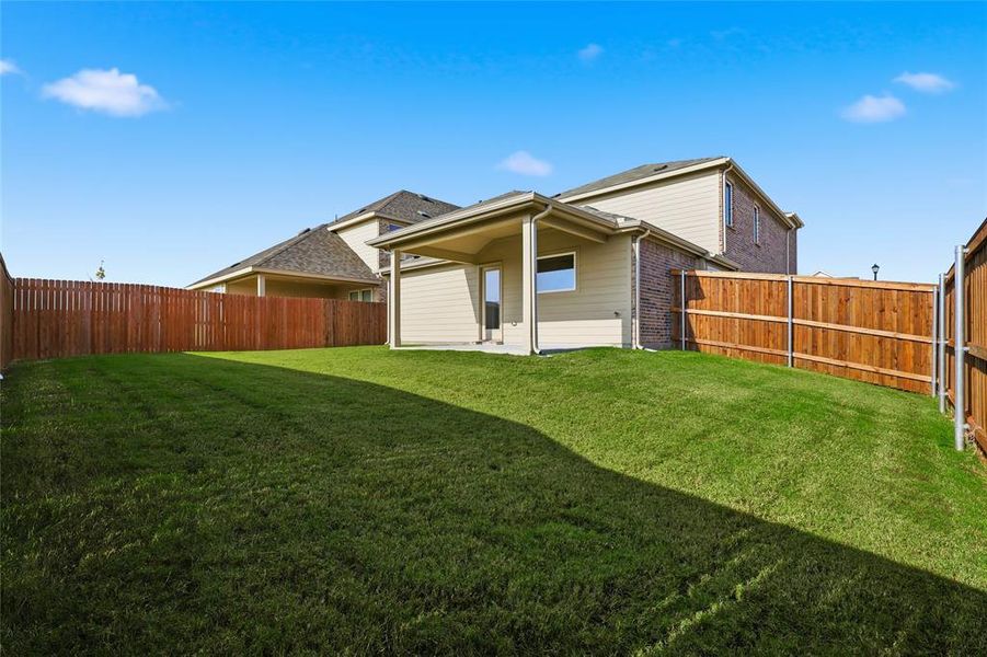 Back of house featuring a patio area, a fenced backyard, and brick siding Back of house featuring a patio area, a fenced backyard, and brick siding
