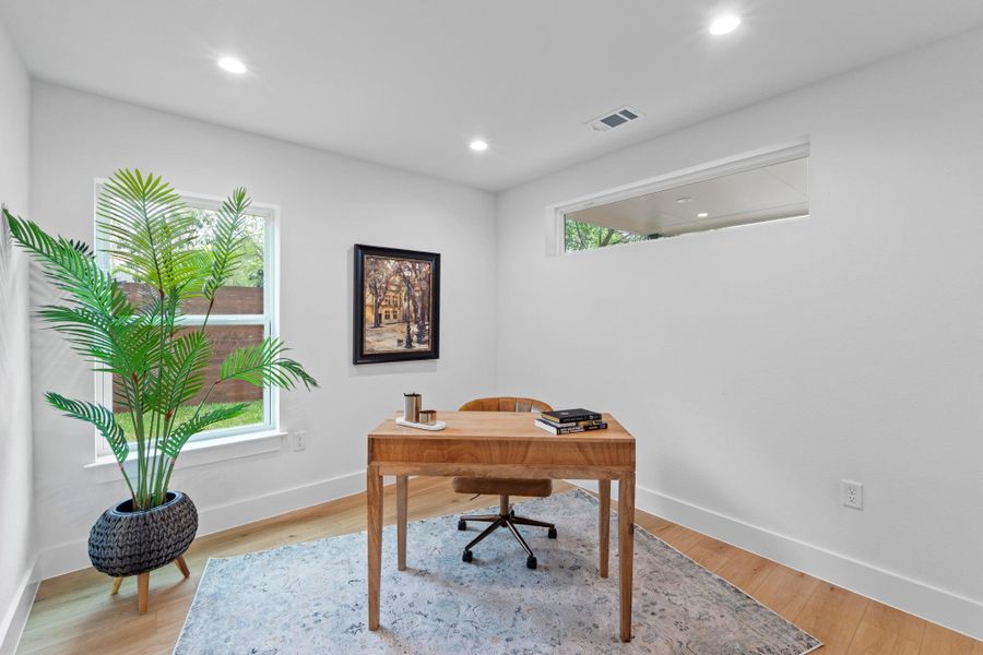 Gleaming wood flooring and clean lines define this modern home workspace.