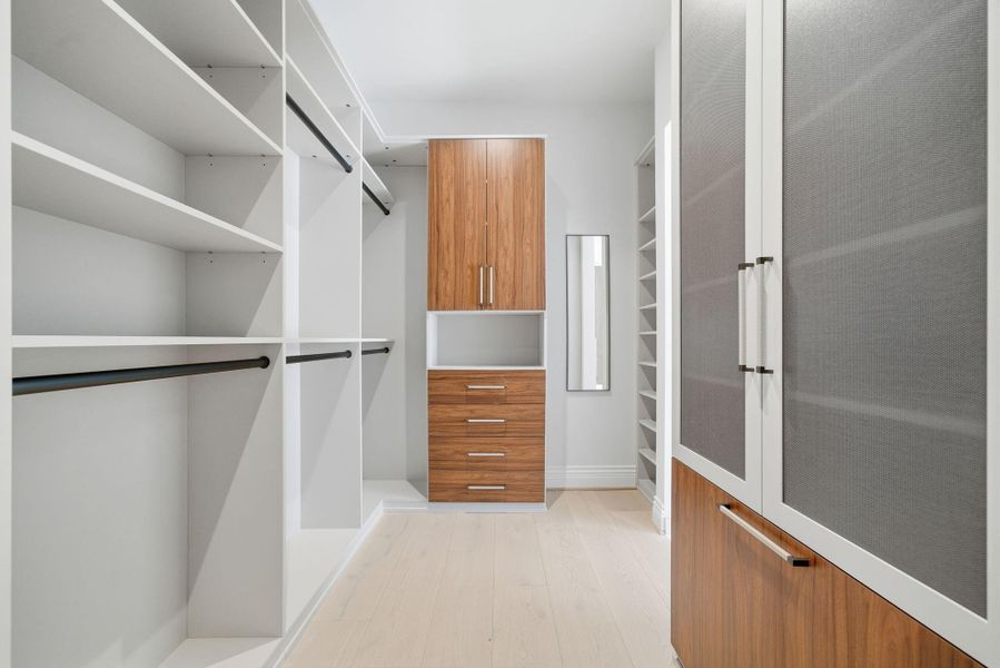 Elevated with custom California Closet system, transforming this space into a sophisticated dressing room. Elevated with custom California Closet system, transforming this space into a sophisticated dressing room.