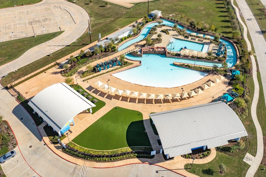 This image provides an aerial view of the lazy river, wave pool, family pool, cabanas, covered seating, and picnic area.