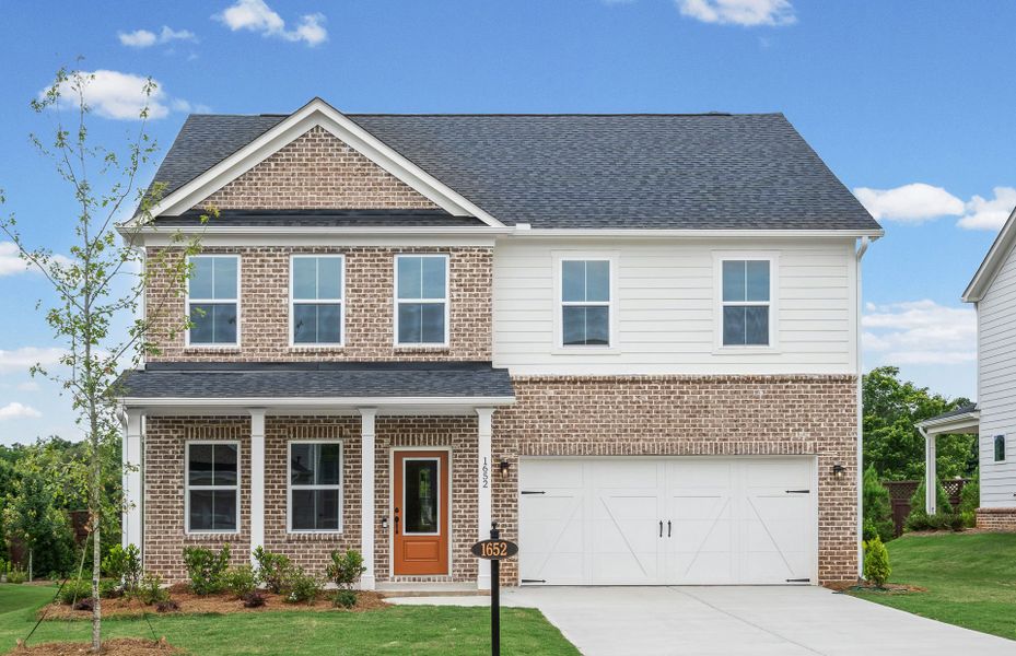 Front exterior of a new home in Berkeley Mill, Cumming, GA, highlighting curb appeal (Image 2). Front exterior of a new home in Berkeley Mill, Cumming, GA, highlighting curb appeal (Image 2).
