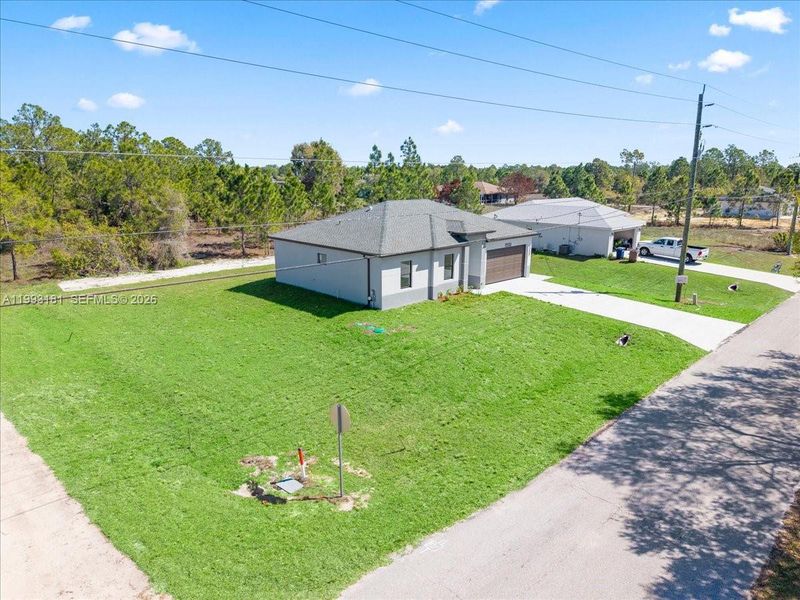 Front exterior of a new home in , Lehigh Acres, FL, highlighting curb appeal (Image 8).