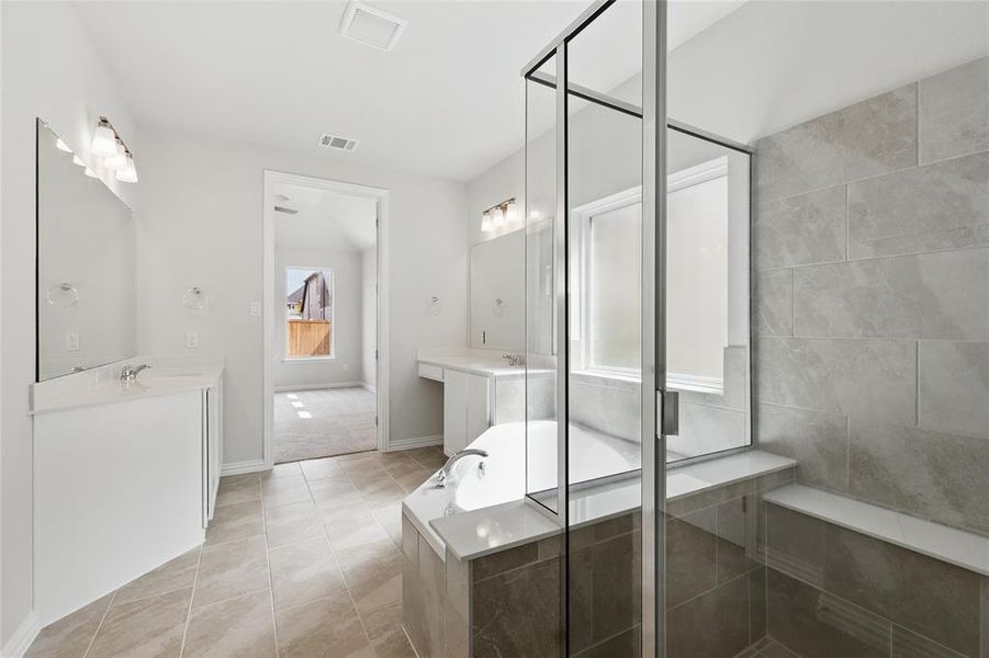 Bathroom featuring tile patterned floors, visible vents, a stall shower, and vanity Bathroom featuring tile patterned floors, visible vents, a stall shower, and vanity