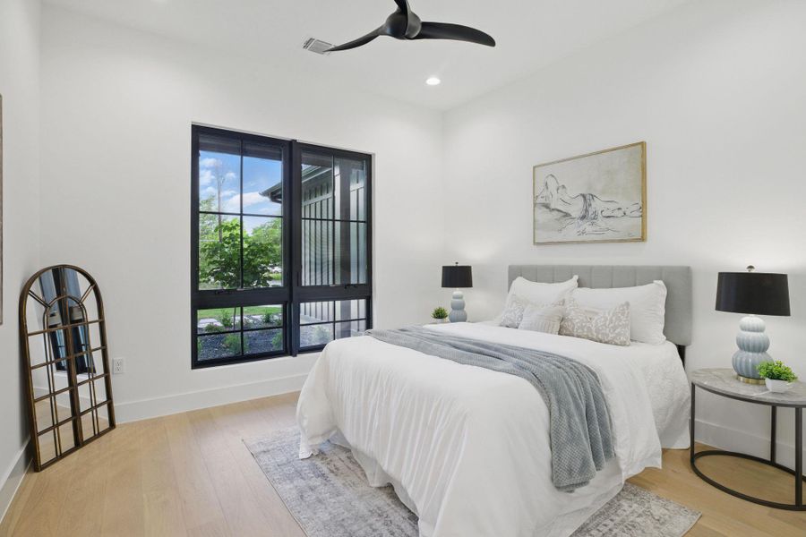 Bedroom with light wood-type flooring, baseboards, recessed lighting, and ceiling fan