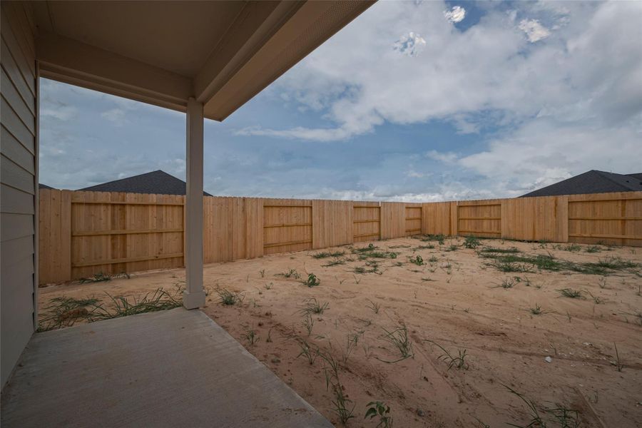 Exterior details and patio area of a home in Woodland Lakes, Huffman (Image 27).
