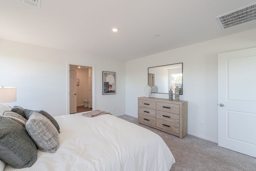 A bedroom with a bed and dresser. A bedroom with a bed and dresser.