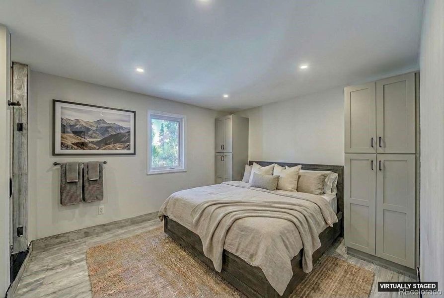 Main level ensuite Guest Bedroom 1 virtually staged