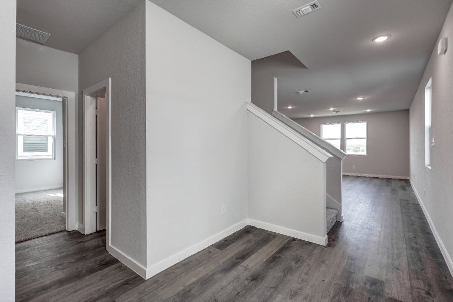 A room with a wood floor and white walls. A room with a wood floor and white walls.