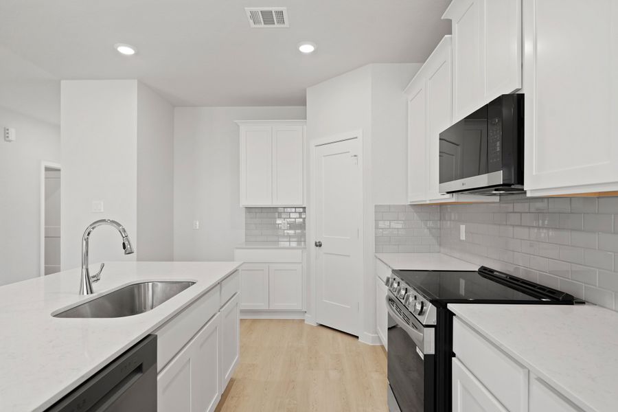 A kitchen with white cabinets. A kitchen with white cabinets.