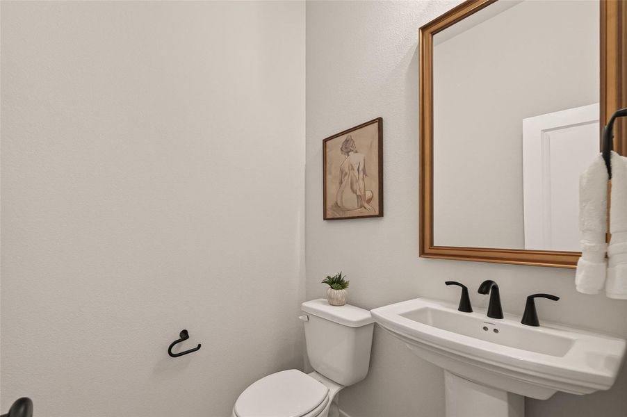 Half bath, adjacent to the kitchen.