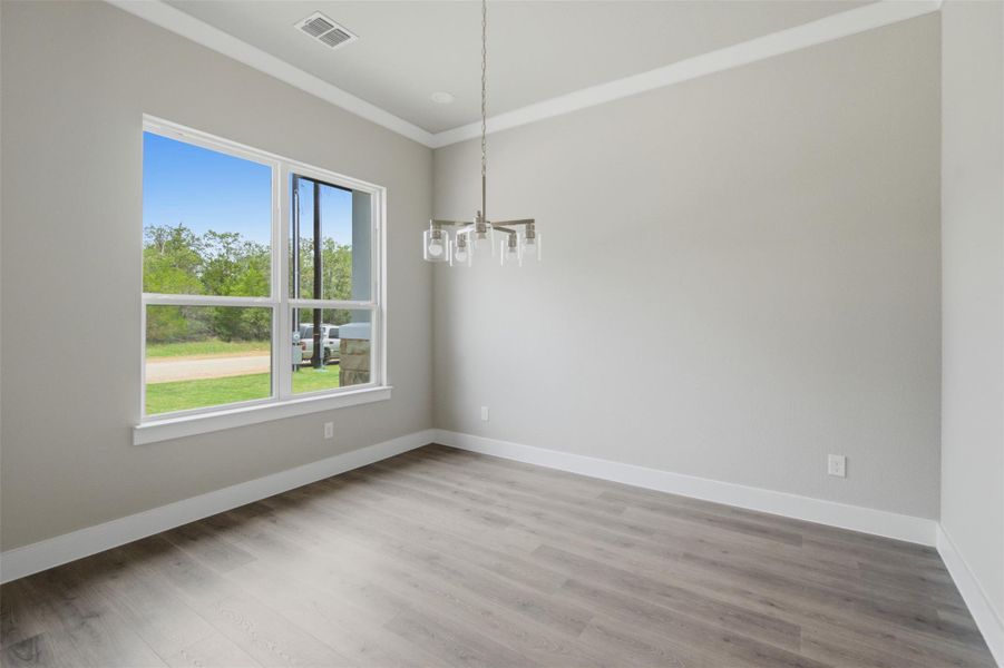A well-proportioned room with ample natural illumination and elegant wood flooring, creating a versatile living area. A well-proportioned room with ample natural illumination and elegant wood flooring, creating a versatile living area.