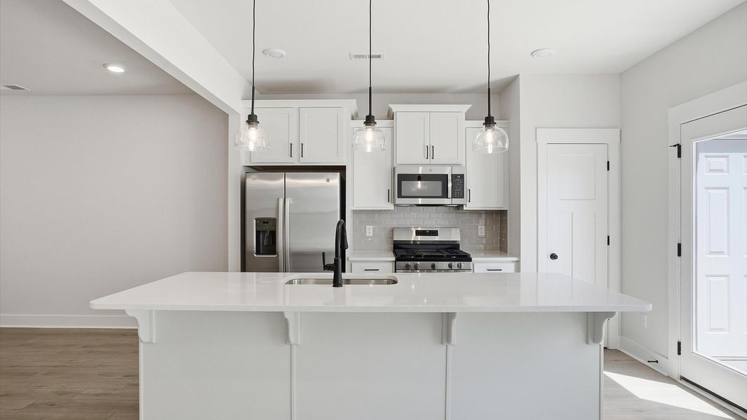 Exclusive kitchen design with large island, pendant lights, and tasteful finishes throughout near Downtown Greenville