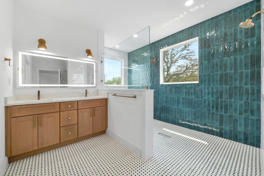 Bathroom featuring a walk in shower, double vanity, recessed lighting, and tile walls Bathroom featuring a walk in shower, double vanity, recessed lighting, and tile walls