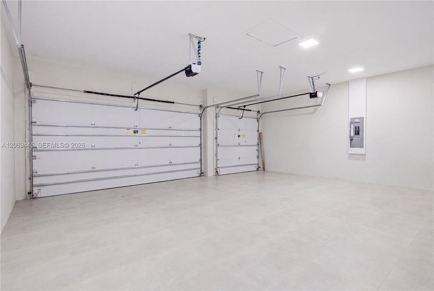 Spacious tiled 3-car garage offers a clean, polished finish with ample room for vehicles and storage. Spacious tiled 3-car garage offers a clean, polished finish with ample room for vehicles and storage.