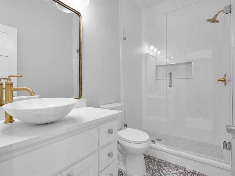 Bathroom with vanity, toilet, and an enclosed shower