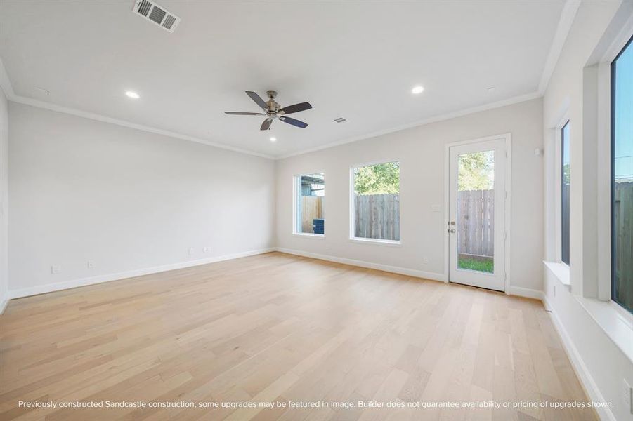 The bright living room overlooks the expansive backyard, creating an inviting space for relaxation and entertaining.