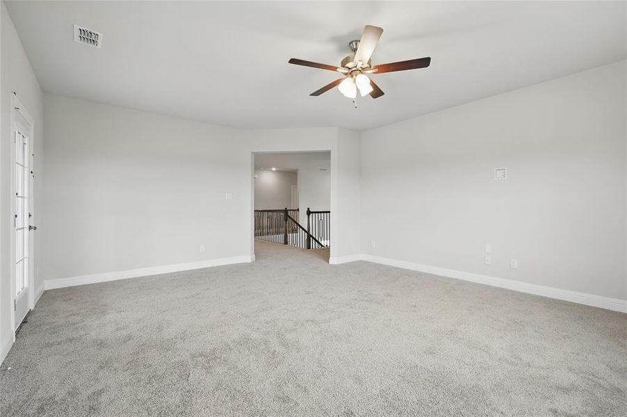 Carpeted spare room featuring a ceiling fan and baseboards Carpeted spare room featuring a ceiling fan and baseboards