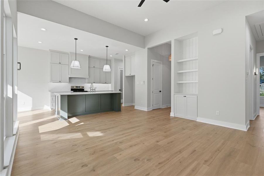Open-concept living area featuring wood-finish flooring throughout Open-concept living area featuring wood-finish flooring throughout