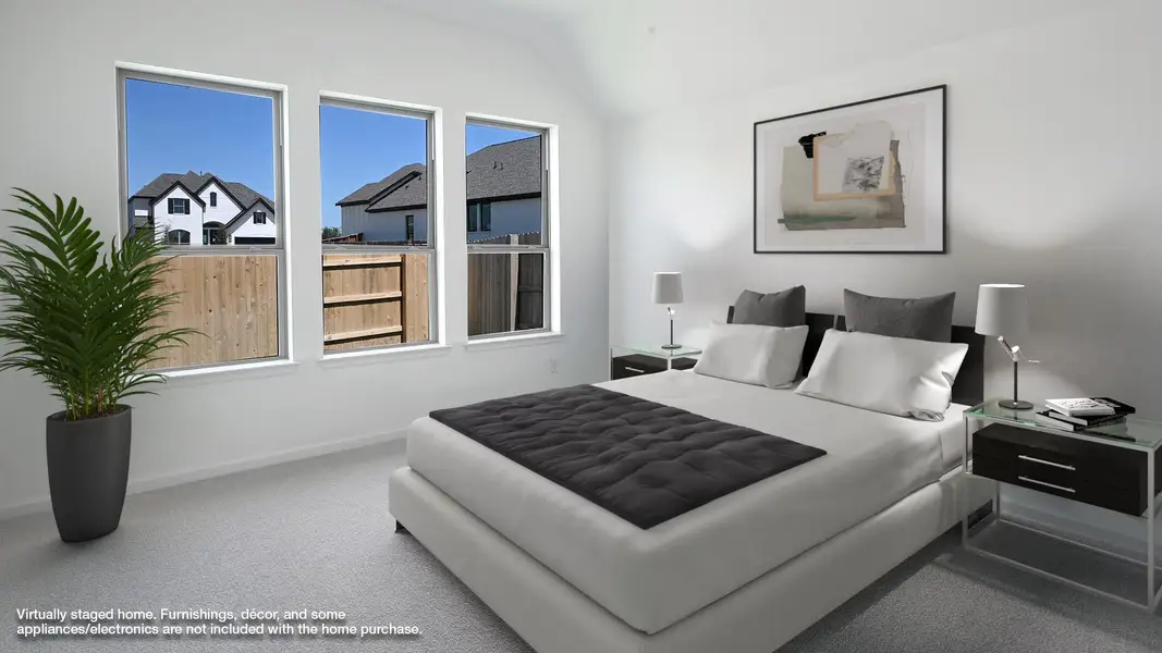Bedroom with carpet and lofted ceiling Bedroom with carpet and lofted ceiling