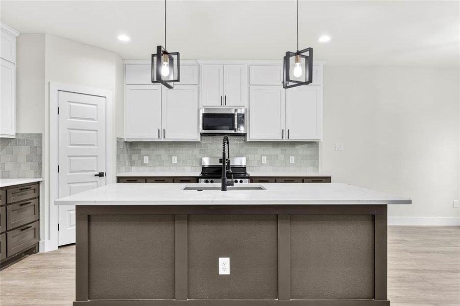 Dining area featuring wood-finish flooring, two large windows with white trim, a modern black geometric chandelier, and light gray walls