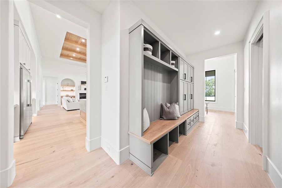 Mudroom featuring light wood finished floors and recessed lighting