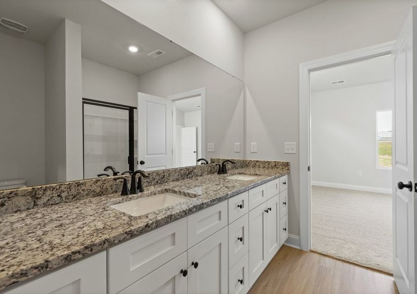 The master bathroom has a glass-enclosed shower and walk-in closet