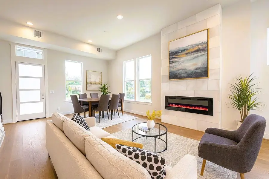 Sleek Electric Flame Color Changing Fireplace Encased in a Marble Surround from Floor to Ceiling (pic was virtually staged)
