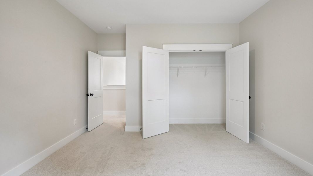 Bedroom with carpet and closet Bedroom with carpet and closet