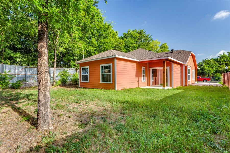 Rear view of property featuring a lawn